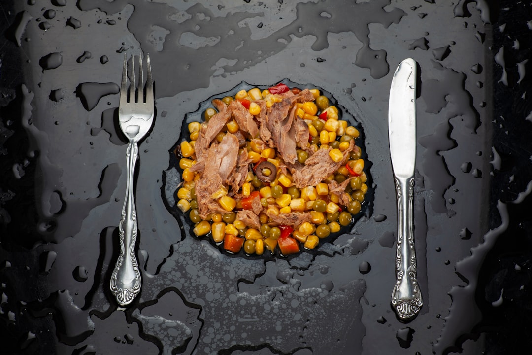 A plate piled high with various junk foods like chips, cookies, and candy.