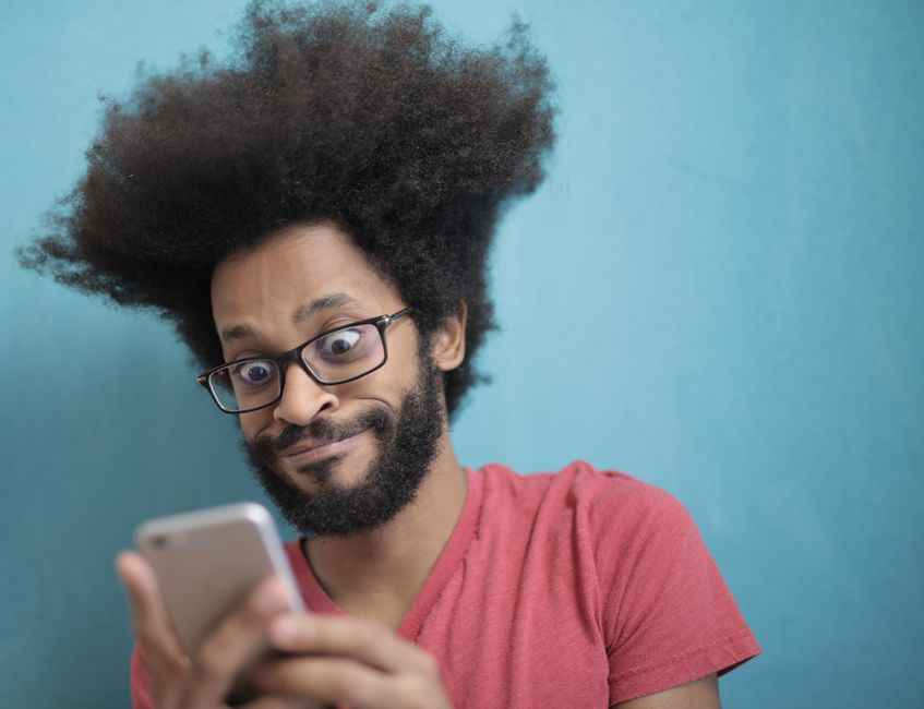 A person with a concerned and confused expression looks at their smartphone, representing the user's doubt when receiving unreliable health advice from an AI chatbot.